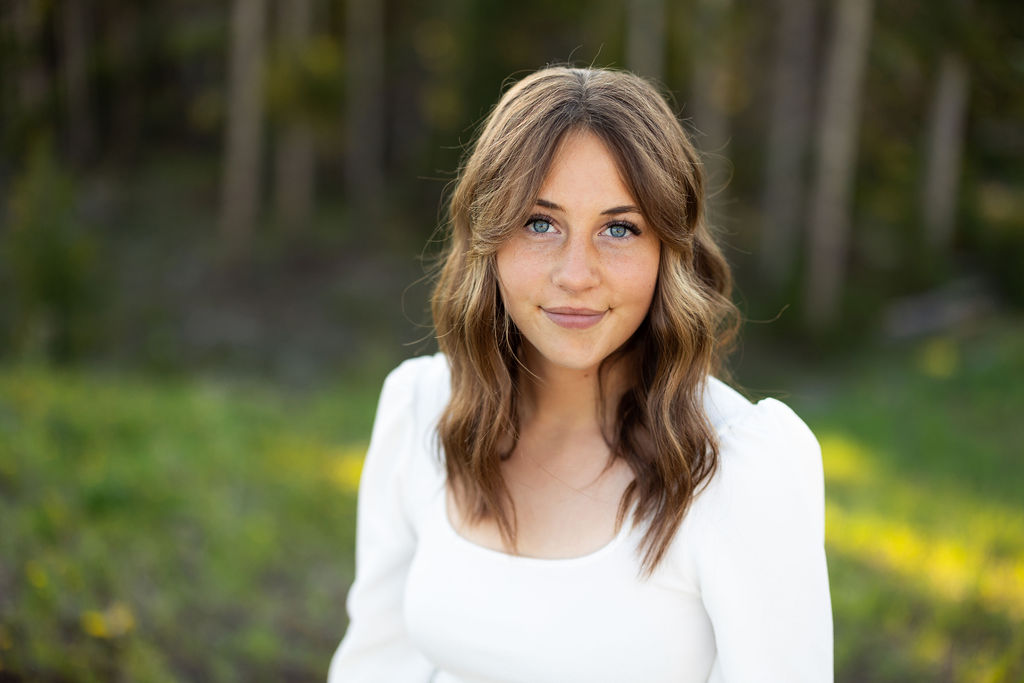 Cadee Hess A girl with brown hair and a white top