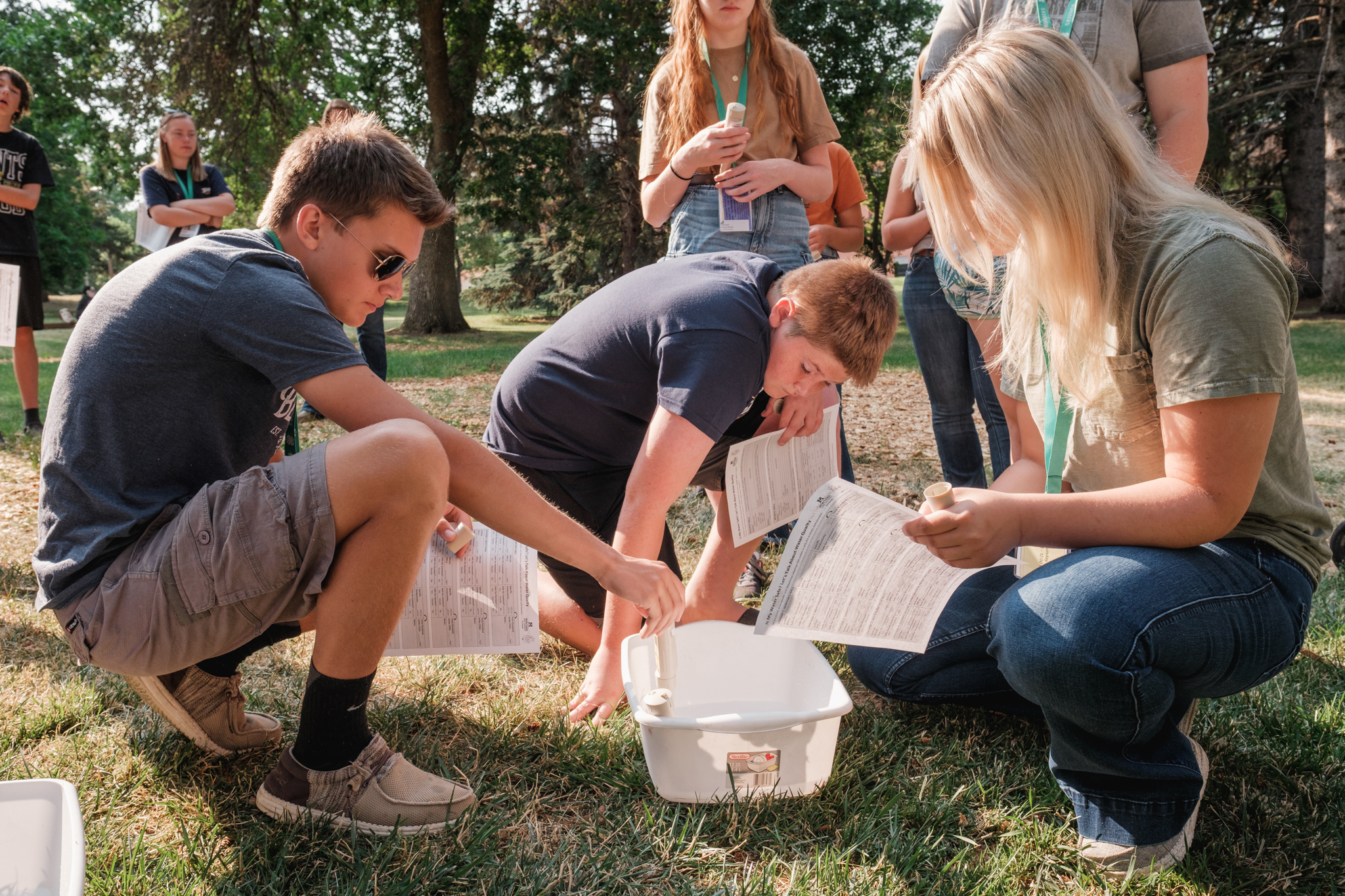 a group of teens work on a science experiment