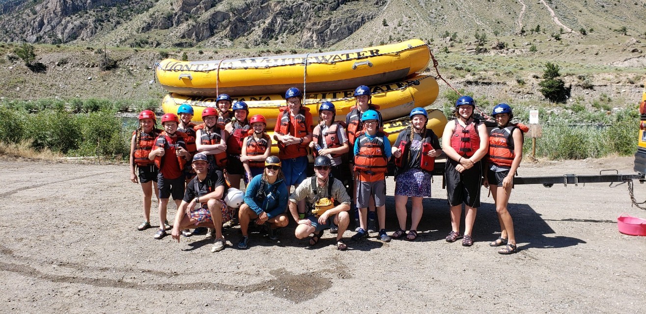 4-H club white water rafting A 4-H club poses in front of a whitewater raft