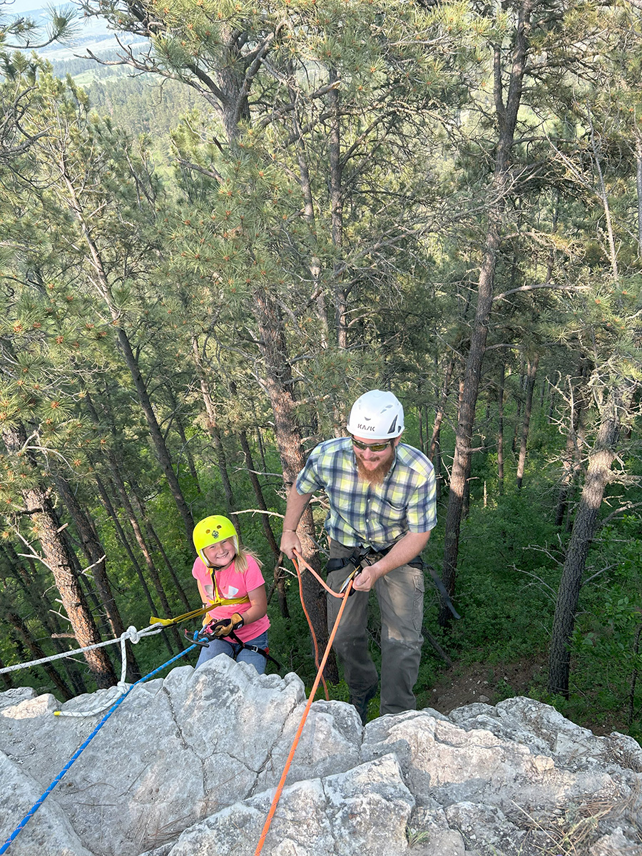 New repelling equipment being put to good use at 4-H camp by youth and adult volunteer.