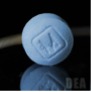 A lab image of a light blue round pill