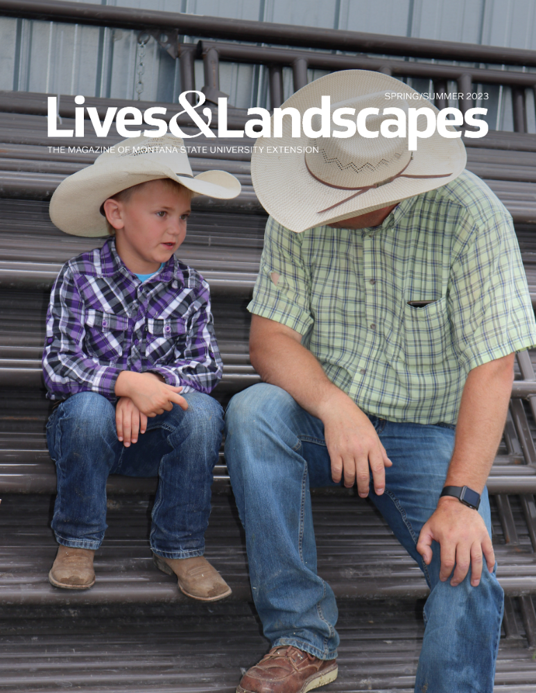 A young boy and a man wearing cowboy hats and plaid shirts sit in conversation.