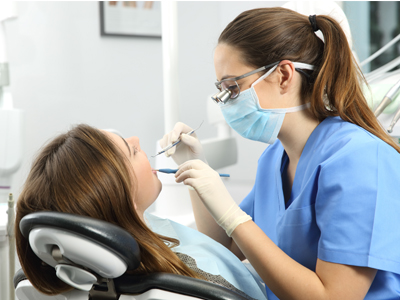 dental hygiene degree A dental hygenitist give a patient and cleaning.