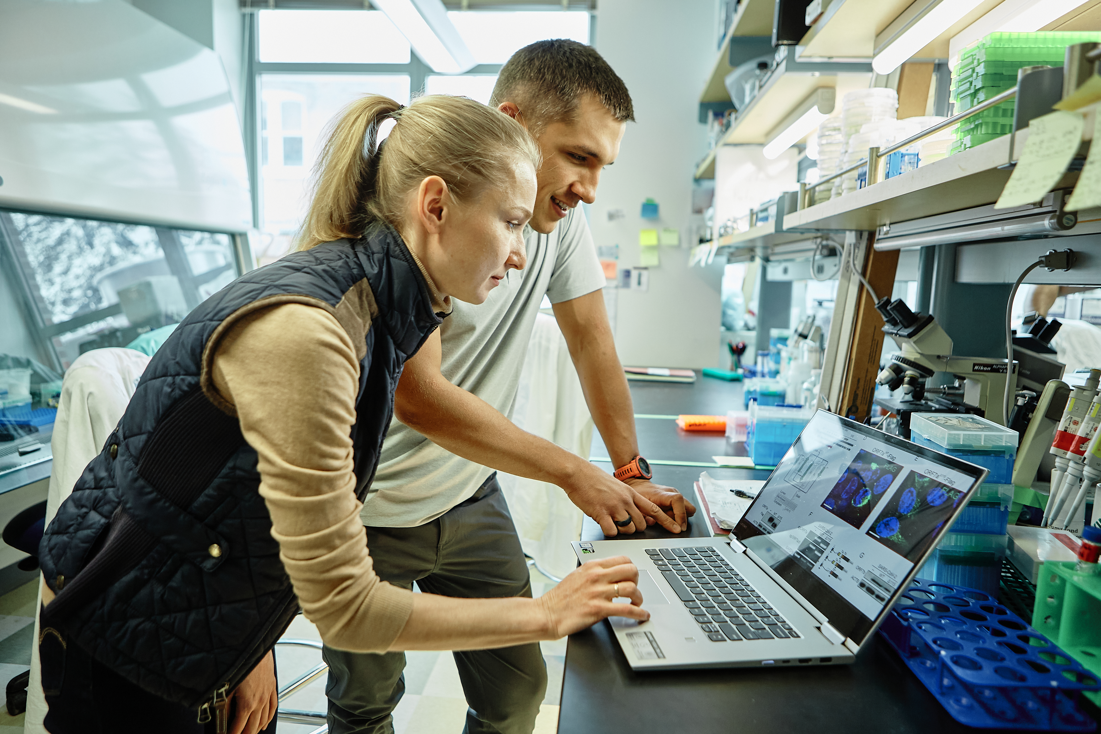 man and woman with laptop in lab